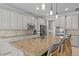 Granite kitchen island with seating and stainless steel appliances at 12023 Gold Creek Trl, Windermere, FL 34786