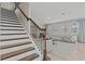Elegant staircase with dark wood steps and wrought iron railing at 12023 Gold Creek Trl, Windermere, FL 34786