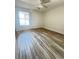 Bright bedroom with wood-look tile floors and large window at 1234 Sago Palm Blvd # 1234, Kissimmee, FL 34741