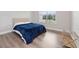 Comfortable bedroom with blue blanket and wood flooring at 13333 Oakenshaw Ln, Orlando, FL 32832