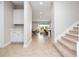 Bright and airy entryway with tile floors, white cabinets, and a carpeted staircase at 13333 Oakenshaw Ln, Orlando, FL 32832