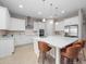Modern kitchen with white cabinets, quartz countertops, and stainless steel appliances at 13333 Oakenshaw Ln, Orlando, FL 32832