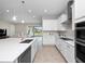Bright kitchen with white cabinets, stainless steel appliances, and view of backyard at 13333 Oakenshaw Ln, Orlando, FL 32832