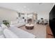 Spacious living room featuring a light-colored sectional sofa and a marble top coffee table at 13333 Oakenshaw Ln, Orlando, FL 32832