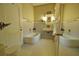 Bathroom with double sinks, a tub and decorative wallpaper at 1401 E Lakeview Ave, Eustis, FL 32726