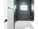 Clean bathroom with dark tile and a white bathtub at 1513 23Rd St, Orlando, FL 32805