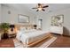 Virtually staged bedroom with wood floors and large bed at 168 Bethel Oaks Ln, Deltona, FL 32738