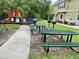 Community picnic tables and grills near playground at 2204 San Vittorino Cir # 107, Kissimmee, FL 34741