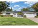 Front view of a single-story house with a large lawn and a two-car garage at 253 Tollgate Trl, Longwood, FL 32750