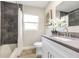 Updated bathroom with gray tile shower and white vanity at 2827 Euston Rd, Winter Park, FL 32789