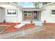 Front porch entry with a unique swing and landscaping at 2827 Euston Rd, Winter Park, FL 32789