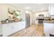 Modern kitchen with stainless steel appliances and light wood laminate floors at 2827 Euston Rd, Winter Park, FL 32789