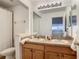 Bathroom with double sinks and wood cabinets at 5516 Remsen Cay Ln, Windermere, FL 34786