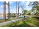A paved walkway winds along a pond, offering scenic community views at 5929 Windhover Dr # A02, Orlando, FL 32819