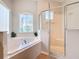 Bathroom with corner bathtub and walk in shower at 611 Tuscan Hills Blvd, Davenport, FL 33897