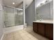 Bathroom with double vanity, tub, and glass shower at 6612 S Goldenrod Rd # 104C, Orlando, FL 32822