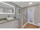 Modern bathroom with granite vanity, frameless shower, and wood-look floors at 7023 Talbot Dr, Orlando, FL 32819