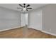 Bedroom with wood-look floors, ceiling fan and access to another room at 7023 Talbot Dr, Orlando, FL 32819