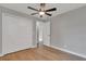 Well-lit bedroom featuring wood-look floors and ample closet space at 7023 Talbot Dr, Orlando, FL 32819