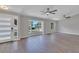Spacious living area showcasing hardwood floors, large windows, and ceiling fans at 7023 Talbot Dr, Orlando, FL 32819