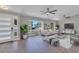 Open living room with hardwood floors, a large window, and stylish furniture at 7023 Talbot Dr, Orlando, FL 32819