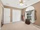 Bright bedroom with arched window and double doors at 705 Willow Run St, Minneola, FL 34715