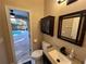 Small bathroom with pool view, updated vanity and toilet at 810 E Yorkshire Dr, Deland, FL 32724