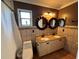 Bathroom with double vanity, updated fixtures and decorative mirrors at 810 E Yorkshire Dr, Deland, FL 32724