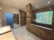 Elegant bathroom with double sinks, large shower, and glass block window at 810 E Yorkshire Dr, Deland, FL 32724