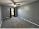 Bright bedroom with gray walls, carpet, and large window at 810 E Yorkshire Dr, Deland, FL 32724