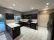 Spacious kitchen with dark cabinets, stainless steel appliances, and white countertops at 810 E Yorkshire Dr, Deland, FL 32724