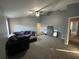 Large living room with gray carpet and sectional sofa at 810 E Yorkshire Dr, Deland, FL 32724