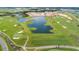 Aerial view of a golf course community with lush greens and water features at 8823 Interlocking Ct, Davenport, FL 33896