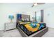 Guest bedroom with a queen bed, sunflower bedding and carpet flooring at 8823 Interlocking Ct, Davenport, FL 33896