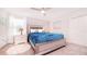 Guest bedroom with a queen bed, blue bedding and carpet flooring at 8823 Interlocking Ct, Davenport, FL 33896