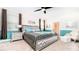 Primary bedroom with a large bed, teal accents and carpet flooring at 8823 Interlocking Ct, Davenport, FL 33896