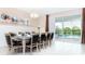 Spacious dining room with large table, chandelier, and view of the pool at 8823 Interlocking Ct, Davenport, FL 33896