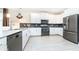 Modern kitchen with white cabinets, dark countertops, and stainless steel appliances at 8823 Interlocking Ct, Davenport, FL 33896