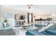 Open living room with sectional sofa and large TV at 8823 Interlocking Ct, Davenport, FL 33896