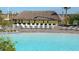 Pool with lounge chairs under a thatched-roof palapa at 8823 Interlocking Ct, Davenport, FL 33896
