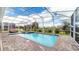 Screened-in pool and spa area with ample patio space at 8823 Interlocking Ct, Davenport, FL 33896