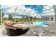 Screened patio with pool, spa and lounge chairs at 8823 Interlocking Ct, Davenport, FL 33896
