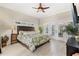 King-size bedroom with a large window and an ensuite bathroom at 9302 Bay Vista Estates Blvd, Orlando, FL 32836