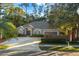 Gray one-story home with a large driveway and landscaped yard at 9302 Bay Vista Estates Blvd, Orlando, FL 32836