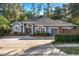 Gray house with gray roof, brick wall, and landscaping at 9302 Bay Vista Estates Blvd, Orlando, FL 32836