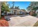 One story house with a gray exterior, landscaping, and a large driveway at 9302 Bay Vista Estates Blvd, Orlando, FL 32836