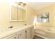 Bathroom with double vanity, large bathtub, and window at 165 Moss Dr, Debary, FL 32713