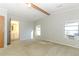 Primary bedroom with two windows, window AC unit, and bathroom access at 165 Moss Dr, Debary, FL 32713