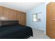 Spacious bedroom with wood paneling and a window at 165 Moss Dr, Debary, FL 32713