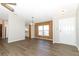 Dining area with wood-paneled walls and vinyl flooring, view of kitchen at 165 Moss Dr, Debary, FL 32713
